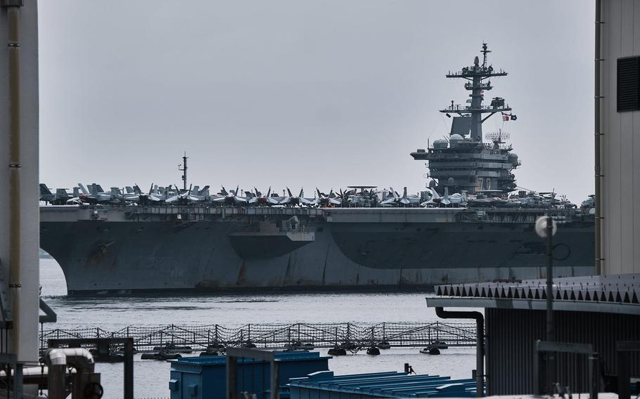 The aircraft carrier USS Abraham Lincoln steams toward Yokosuka Naval Base, Japan, Saturday, May 21, 2022.