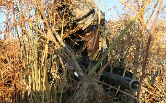 Pir Ahmad, Iraq, Dec. 10, 2007: Cpl. Issac Ounda, 27, of Nairobi, Kenya, pulls rear security during an ambush early Monday outside the village of Pir Ahmad. Ounda is with Troop C, 1st Squadron, 71st Cavalry Regiment, 10th Mountain Division. The mission was meant to kill or capture four members of an insurgent cell who planted a bomb last month that killed two soldiers with the unit. But the insurgents failed to materialize. 

RELATED: From the Archives, 2007: Ambush plan fails to net quarry. https://www.stripes.com/news/ambush-plan-fails-to-net-quarry-1.72284

META TAGS: Operation Iraqi Freedom, War on Terror, U.S. Army, 10th Mountain Division; 
