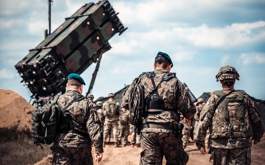 Service members from the U.S. and Polish armies walk to the site of a Patriot missile system near Drawsko Pomorskie, Poland in 2018. Two U.S. Patriot missile batteries have been dispatched to Poland, U.S. European Command said March 9, 2022. 