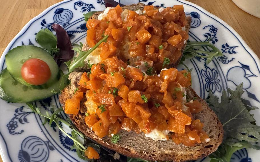 Bread with cheese and chutney topping on a plate.