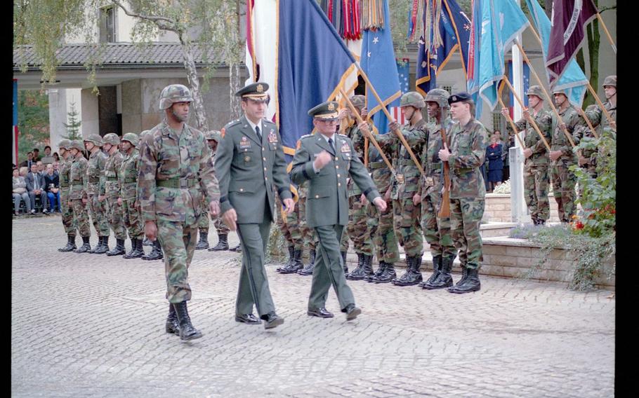 U.S. City Commander Berlin Maj. Gen. Raymond Haddock, center, and Lt. Gen. John Shalikashvili, the deputy commander in chief, U.S. Army Europe, right, walk through an honor formation during a military decommissioning ceremony for U.S. Army Command Berlin on Oct. 1, 1990.