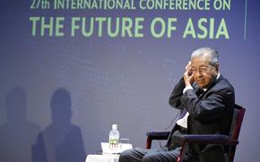 Malaysia's former Prime Minister Mahathir Mohamad adjusts an earphone before answering questions at a session of the International Conference on "The Future of Asia" Friday, May 27, 2022 in Tokyo. (AP Photo/Eugene Hoshiko)