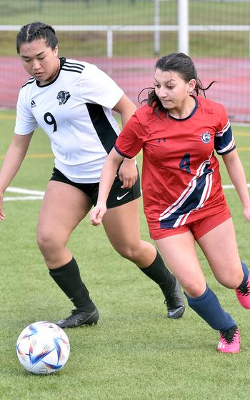 Lakenheath right winger Natalia Maynes looks to get away from Stuttgart defender Ayana Gomez  on Friday evening at Kaiserslautern High School in Kaiserslautern, Germany.