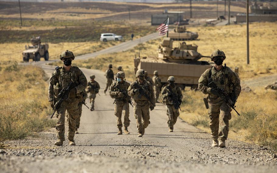 Soldiers with the 1st Battalion, 6th Infantry Regiment make their way to an oil production facility in Syria to meet with its management team in 2020. A new U.S. security strategy document deemphasizes the Middle East, instead focusing on Russia and China.