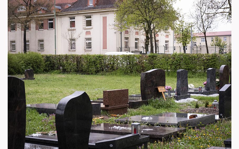 Buildings on Kleber Kaserne in Kaiserslautern, Germany, look over the city’s main cemetery on Friday, April 28, 2023.