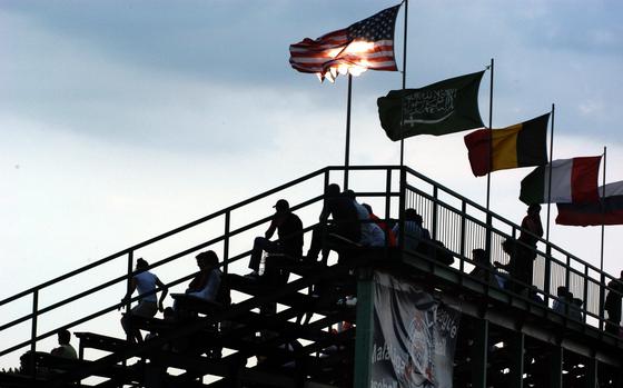 Kutno, Poland, July 23, 2003: Stars and Stripes waves over the stands during the final game of the Little League Baseball's Trans-Atlantic regional playoffs. It flies with glags from (left to right) of Saudi Arabia, Belgium, France and Russia. These countries had teams playing in the two regional finals.        

META DATA: flag; baseball; sports; military life; leisure