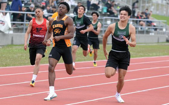 Kadena senior Neil Kentish and Kubasaki junior Ryan Hater come down the stretch side by side in the boys 200 during Friday's Mike Petty Meet. Hater edged Kentish by .04 seconds.