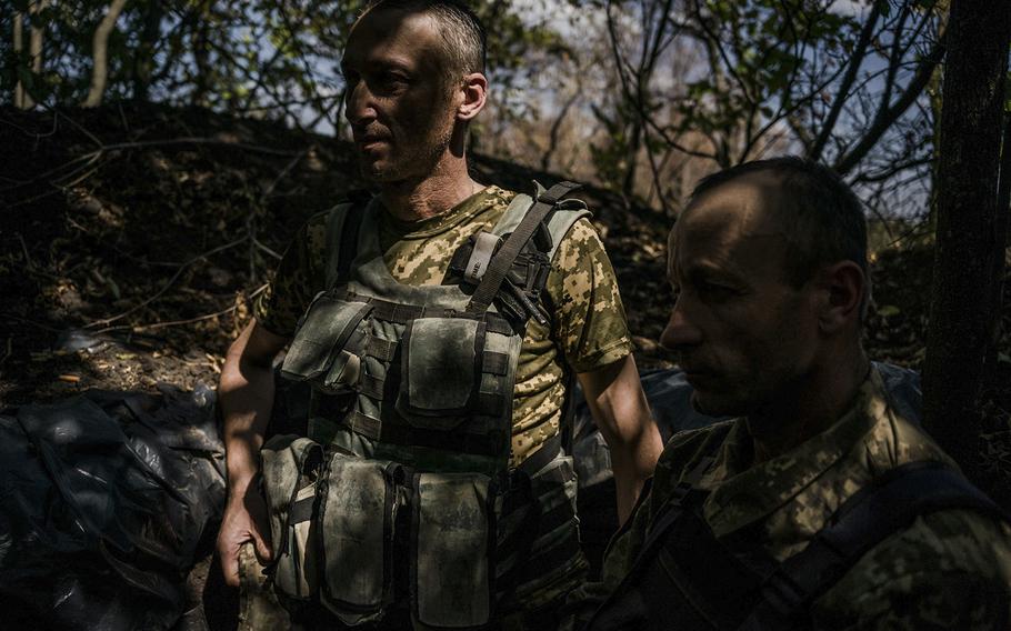 Vitali, 45, left, and Yuri, 44, in the trenches on the Kherson front line, are among the Ukrainian fighters trying to recapture occupied territory that links Russia with Crimea. 