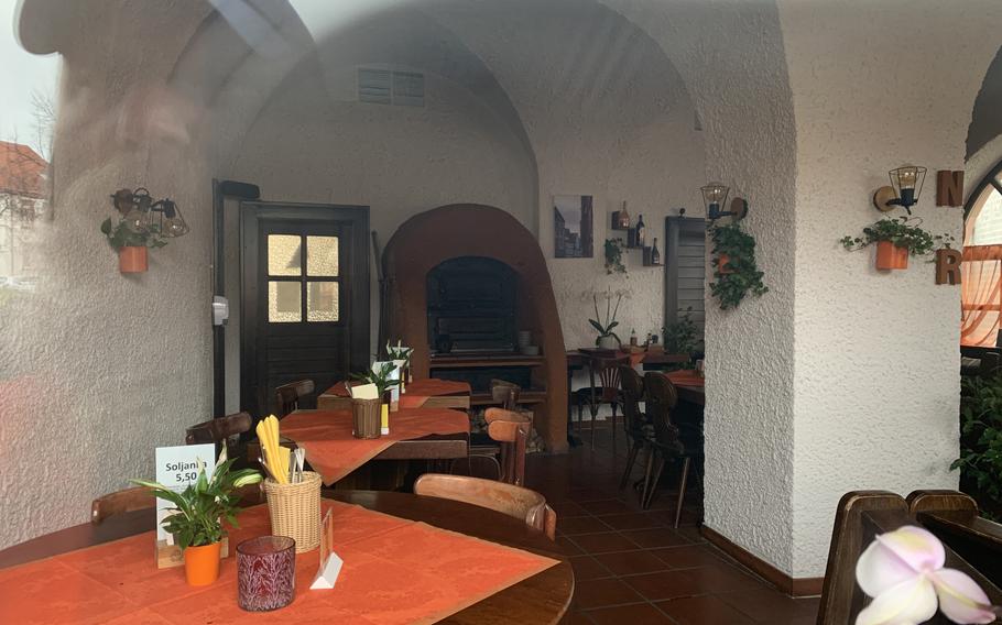 A peek through the windows at Nora Restaurant, where flammkuche is the specialty, a few hours before opening on April 1, 2022, in downtown Kaiserslautern. 