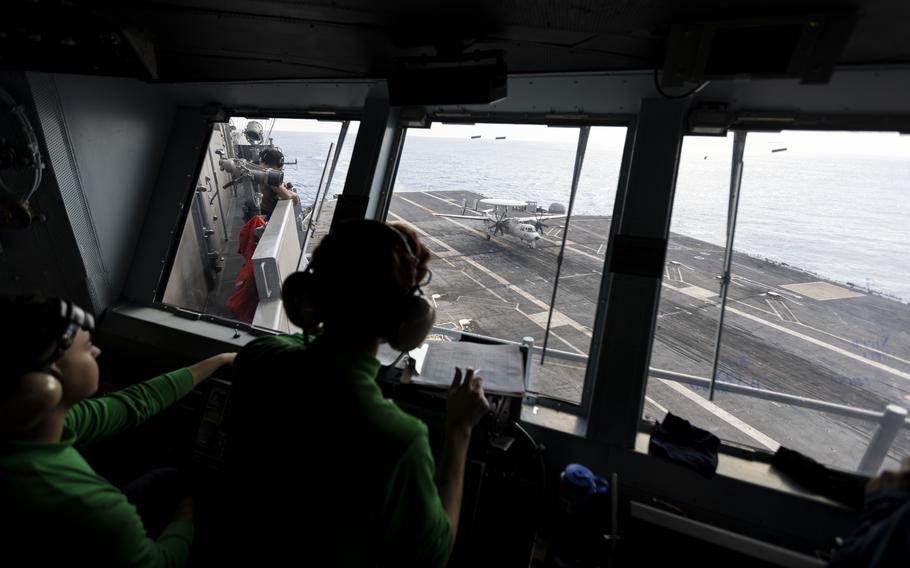 Crew on the primary flight control deck watch as an E-2 Hawkeye lands aboard the USS George Washington (CVN-73) off the coast of Florida on Sept. 14, 2023. 