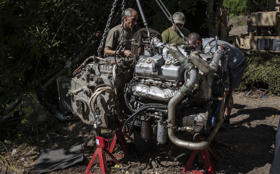 Troops from the 47th work on the engine of an M113 armored personnel carrier.