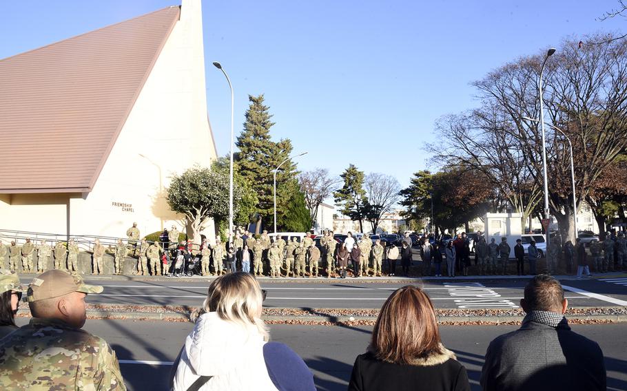 Airmen and other community members wait to pay their respects to fallen Osprey aircrew at Yokota Air Base, Japan, Wednesday, Dec. 13, 2023.