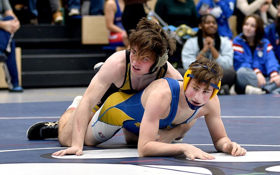 Stuttgart's Zachary Call looks to his coaches as he keeps Wiesbaden's Alexander Brookhart on the mat during a 144-pound match on Saturday at Ramstein High School on Ramstein Air Base, Germany.