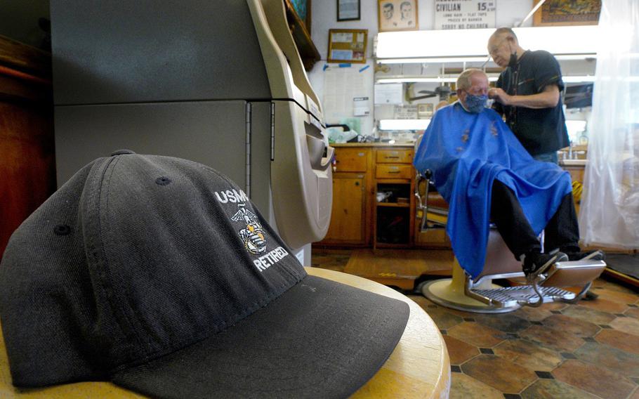 Johnny Gomez, 84, cuts the hair of Richard Mathys, a retired Marine, on Wednesday, Aug. 18, 2021 at Esquire Barber Shop in Oceanside, Calif. 