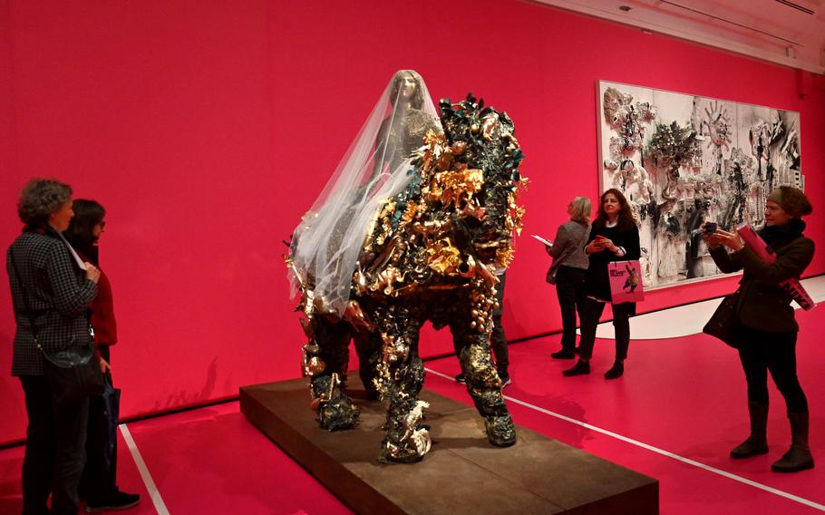 Visitors look at the life-size work by Niki de Saint Phalle, “Bride on Horse,” at the exhibit dedicated to her work at the Schirn in Frankfurt, Germany. In the background is the almost 20-foot long piece titled King Kong. The show runs through May 21, 2023.