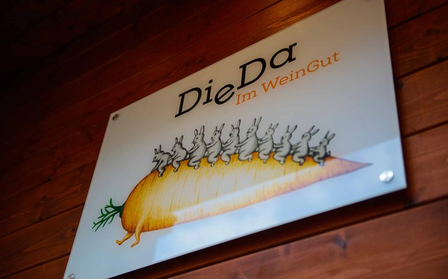 A whimsical sign at DieDa im WeinGut in Bad Duerkheim, Germany, depicts 10 bunnies adorning a two-legged, toppled carrot. The sign was created by Swiss graphic artist Benedikt Notter.