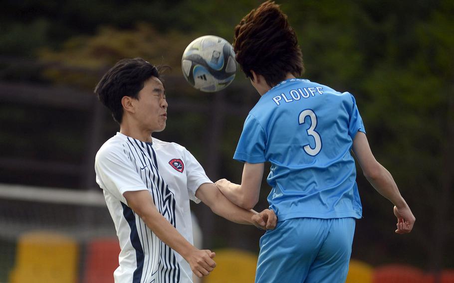 Yongsan International-Seoul's Joshua Park and Osan's Ben Plouff go up to head the ball during Friday's Korea boys soccer match. The Guardians won 5-1.