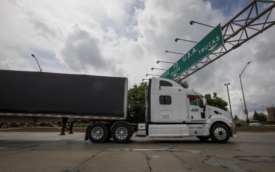 A truck enters a queue to cross the Ambassador Bridge into Detroit, Michigan, from Windsor, Ontario, on May 26, 2021.