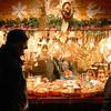 Bad Hersfeld, Germany, Dec. 1, 2006: The child of one of the vendors at the Bad Hersfeld Christmas market is full of holiday cheers as shoppers pass by the stand.

Check out Stars and Stripes' list of German holiday markets here.
https://europe.stripes.com/travel/2023-german-christmas-market-directory.html

META TAGS: German Christmas market; holidays; straw christmas ornaments; tree ornaments; 