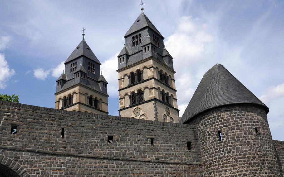 The twin steeples of Sacred Heart of Jesus Church tower over the medieval defensive walls of Mayen, Germany. The steeples are about 141 feet tall.