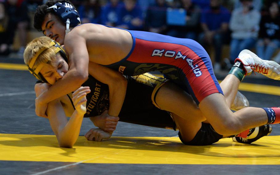 Ramstein’s Jesus Olivares takes down Stuttgart’s Brayden Aperauch on his way to winning the 113-pound title at the DODEA-Europe wrestling championships, in Wiesbaden, Germany, Feb. 11, 2023.