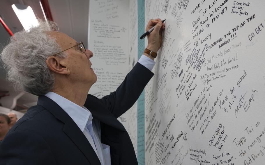 U.S. Ambassador to Denmark Alan Leventhal signs the 12th Space Warning Squadron heritage wall during his visit to Pituffik Space Base, Greenland, April 6, 2023. Leventhal participated in the base renaming ceremony.