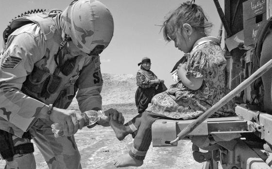 Hed: Washing of the feet, 2006

Ali Base, Iraq, April 2006 - Tech. Sgt. Jeffrey Fort, 33, of Florissant, Mo., an Air Force patrol leader, treats a local child for cuts on her feet during a recent patrol outside Ali Base in Iraq. 

META TAGS: Afghanistan; Operation Enduring Freedom; War on Terror; servicemembers; locals; Afghani; child; children; girl; kindness