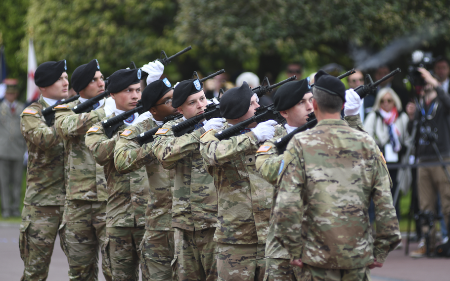 Members of the 207th Military Intelligence Brigade perform a 21-gun salute at the conclusion of the 79th anniversary D-Day remembrance ceremony at Normandy American Cemetery in Colleville-Sur-Mer, France, on Tuesday, June 6, 2023. 