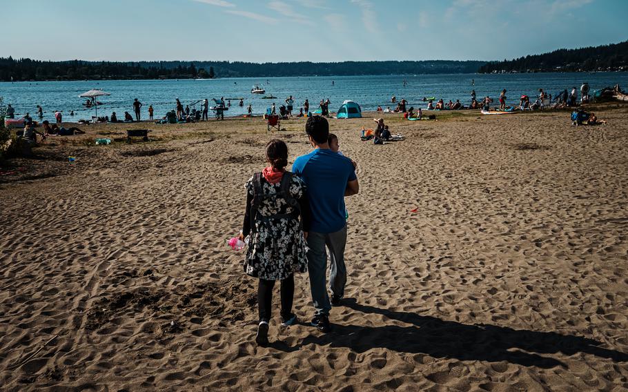 Meena Mosazai, 30, her husband, Matan Atal, 23, and their child, Moska, 1, visit a park near their home in Seattle on Aug. 12, 2022.