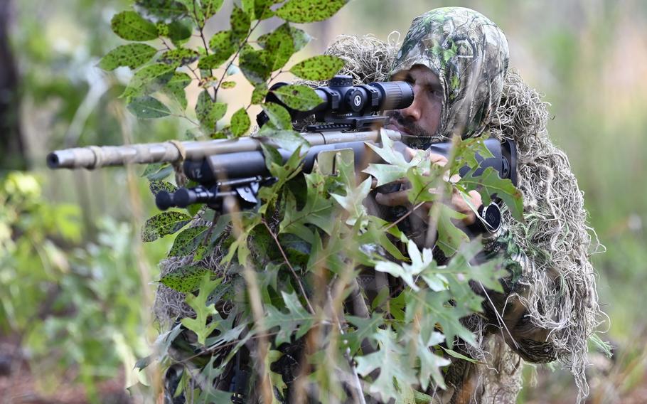 A student assigned to the Special Forces Sniper Course looks through a scope during sniper training at Fort Bragg, N.C. Aug. 2, 2021. A woman recently graduated for the first time from the seven-week conventional sniper course at Fort Benning, Ga., the Army announced.