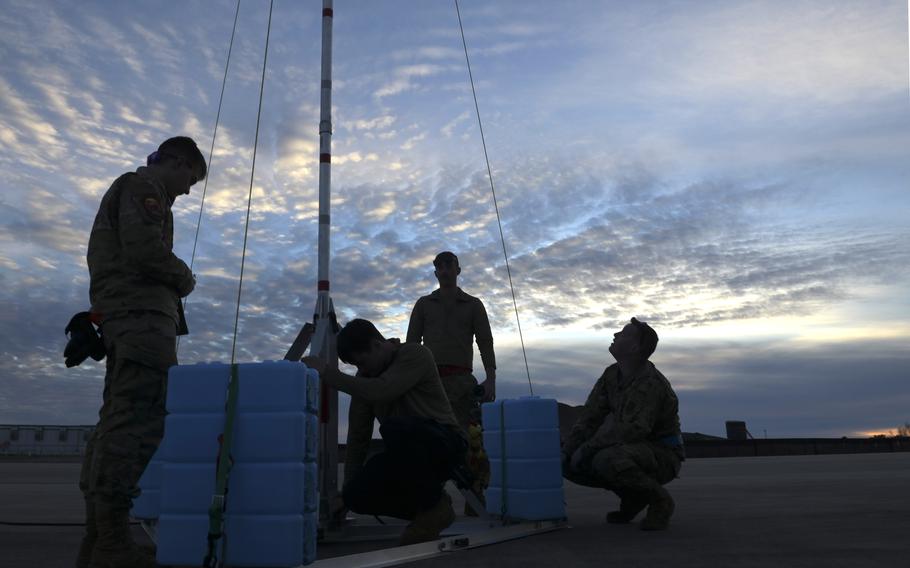 Aircraft maintenance specialists with the Wisconsin Air National Guard’s 115th Fighter Wing raise a grounding rod during a Weapons System Evaluation Program exercise Feb. 13, 2024, at Tyndall Air Force Base, Fla. 