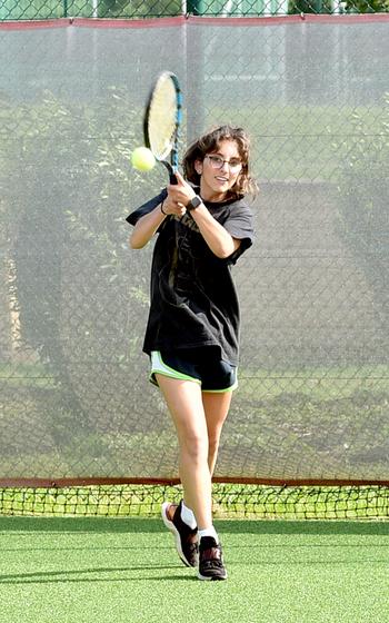 Alisa Dietzel backhands the ball during a tennis practice on Aug. 30, 2023, at Kaiserslautern High School in Kaiserslautern, Germany. This fall, the Raider junior will look to defend her DODEA European doubles title with fellow junior Abby Hover.