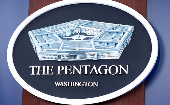 The Department of Defense logo is seen on the wall in the Press Briefing room.