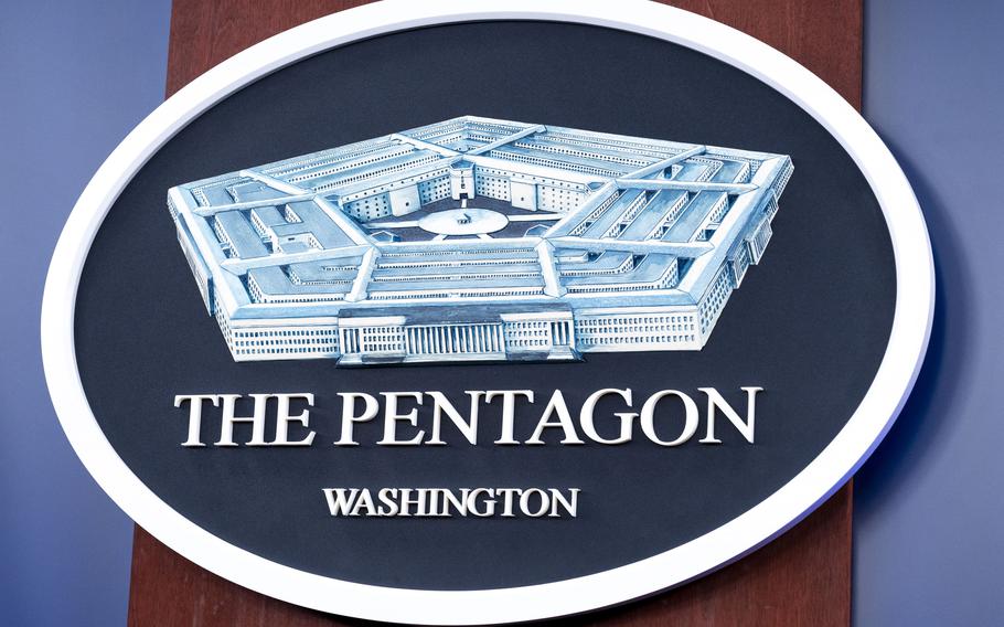 The Department of Defense logo is seen on the wall in the Press Briefing room.