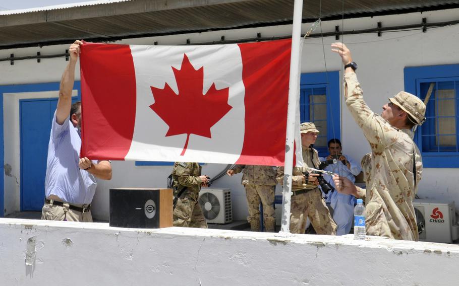 The Canadian flag is lowered for the last time on Camp Nathan Smith in Kandahar City, Afghanistan, June 22, 2011. 