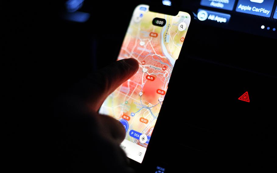 Khalid Payenda looks at his Uber app as he starts his shift. 
