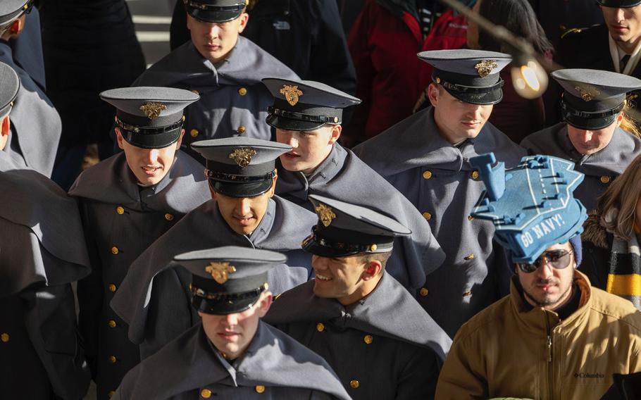 Cadets join the crowd entering the stadium.