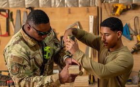 Air Force Staff Sgt. Antonio Harmon, left, and Airman 1st Class Aaron Garcia, stationed at Air Base 201 in Agadez, Niger, build a desk for the local community Feb. 6, 2024. Niger’s military junta announced Saturday that it was severing military ties with the U.S. and revoking a pact that allowed American troops to be based there.