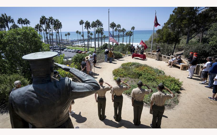 Marines salute as the American flag is lowered to half staff during a remembrance service at Park Semper Fi in San Clemente, CA on Friday, August 26, 2022. The event honored the 13 service members who were killed in a bombing at the Kabul, Afghanistan airport a year earlier during the U.S. withdraw. 