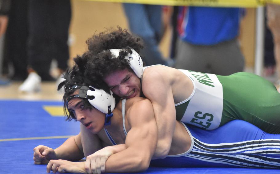 Naples’ Kyson Fromm keeps Ramstein’s Isaac Martinez on the mat at 157 pounds Friday, Feb. 9, 2024, at the DODEA European Wrestling Championships in Wiesbaden, Germany. Martinez would go on to win the match in overtime.