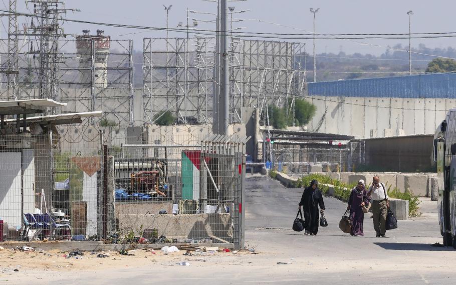 Palestinian patients carry their belongings on their way back to the Gaza Strip after receiving medical treatment in Israel, near the Erez crossing between Gaza and Israel, in the town of Beit Hanoun, northern Gaza Strip, Tuesday, Sept. 19, 2023. 