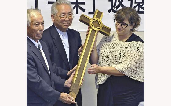 The atomic-bombed cross is returned from Wilmington University to the then-archbishop of Nagasaki in August 2019. MUST CREDIT: The Yomiuri Shimbun.