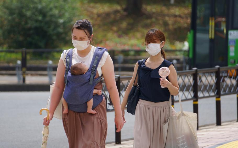 Women in central Tokyo wear masks to help stem the spread of coronavirus on Aug. 27, 2021.