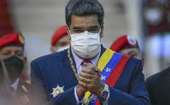 Venezuela's President Nicolas Maduro clasps his hands as he arrives to deliver his State of the Nation address at the National Assembly in Caracas, Venezuela, Saturday, Jan. 15, 2022. (AP Photo/Matias Delacroix)