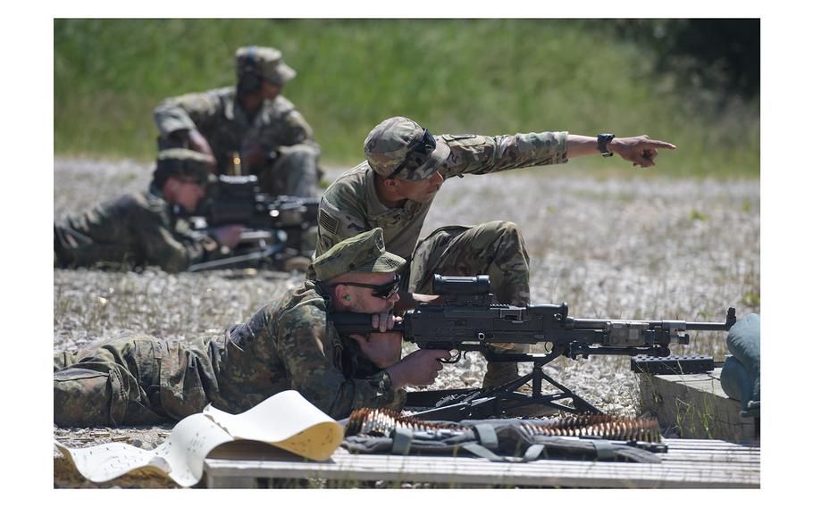 A U.S. Army paratrooper briefs a German soldier on the M240 machine gun during qualification for the Schuetzenschnur, the German Armed Forces badge of marksmanship, at the 7th Army Training Command’s Grafenwoehr Training Area, Germany, on June 17, 2021..