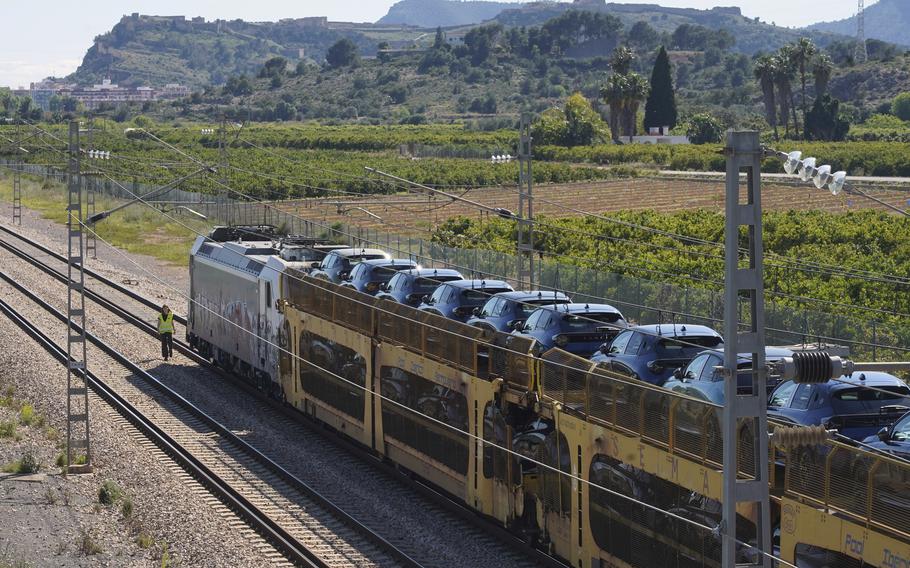 A freight train loaded with cars is stopped on the track during a nationwide power outage in Spain.