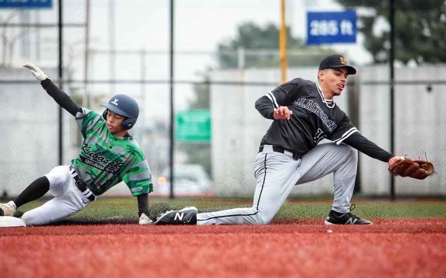 Kubasaki's Rei Koja slides into third base ahead of the throw to Humphreys' Jaeton Abraham.
