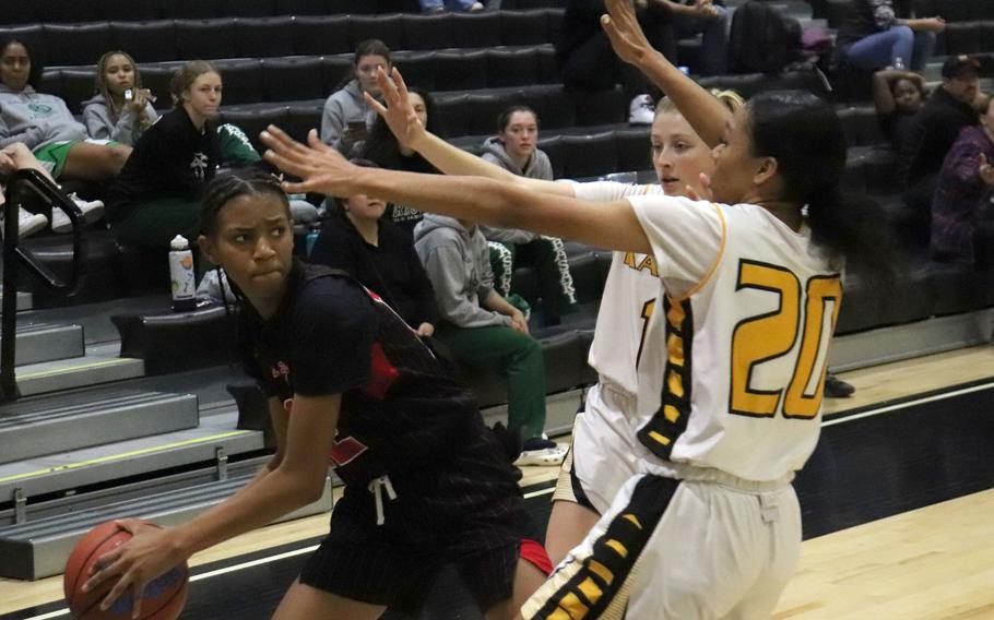 Kinnick's KaMiyah Dabner gets bottled up by Kadena's Cassidy Kimbrough and Ayanna Levi during the girls D-I final.