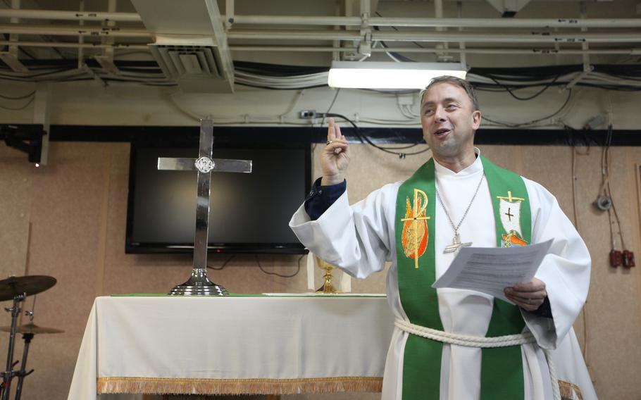 Lt. Cmdr. Daniel Berteau, command chaplain for the Kearsarge Amphibious Ready Group, speaks during a Sunday church service aboard the amphibious assault ship USS Kearsarge. The Kearsarge ARG is supporting Pakistan flood relief efforts. 
