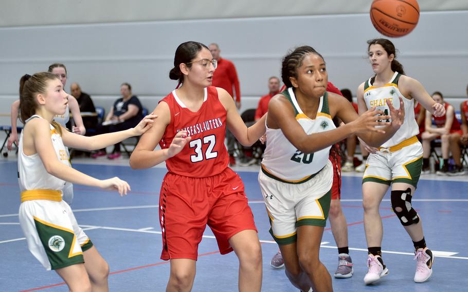 SHAPE's Addie Atkins and Kaiserslautern's Emma Arambula fight for a ball during pool play of the Division I DODEA European Basketball Championships on Wednesday at Ramstein High School on Ramstein Air Base, Germany.